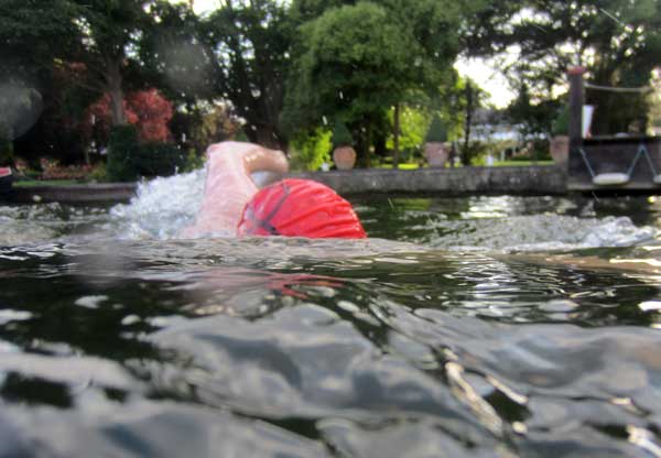 Swimmers from the Lido passing gardens on the Thames.